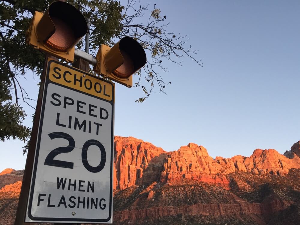 Close-up of Entering To Built-up Area Sign. Reduce Speed and Obey