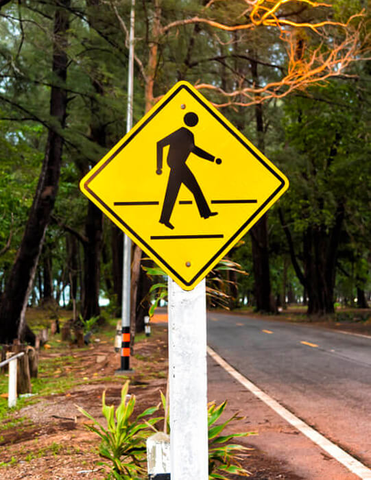 Pedestrian crossing road traffic sign showing a person on a zebra