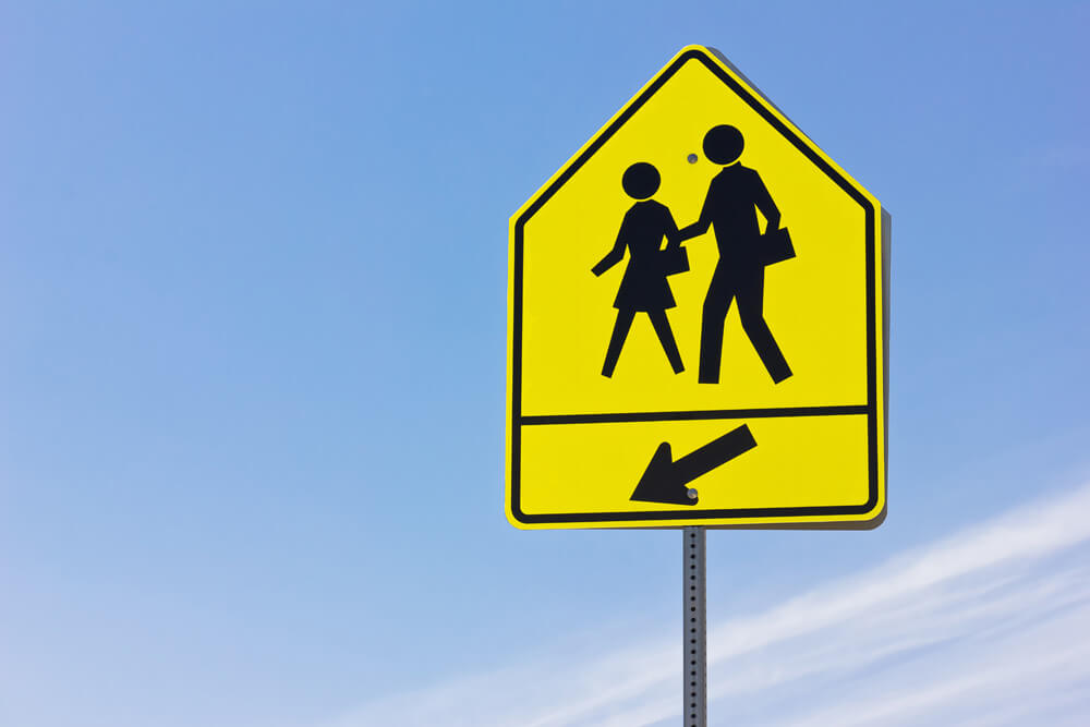 Iconic British road sign of two schoolchildren crossing updated by